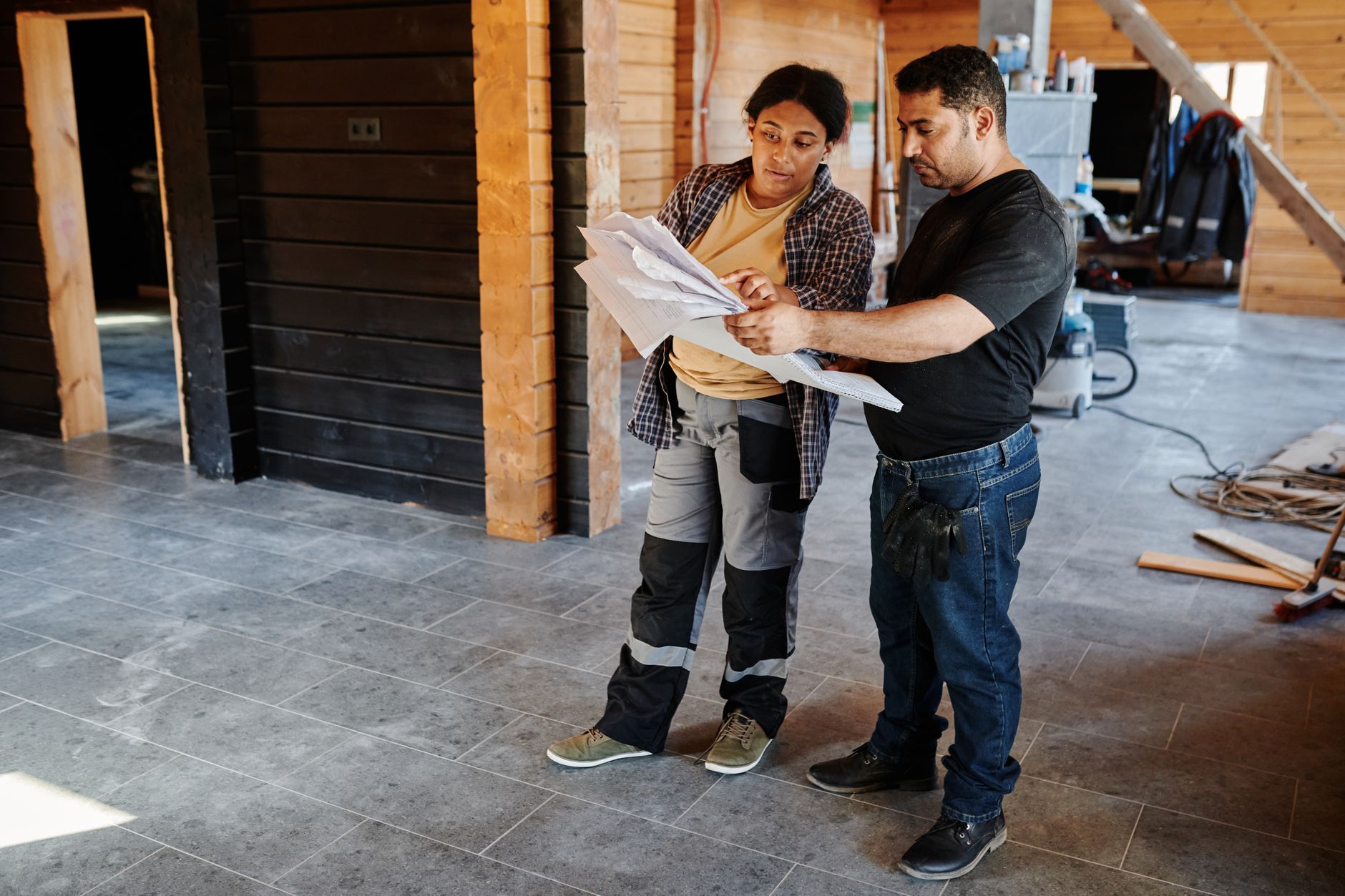 A contractor reviewing plans at a job site